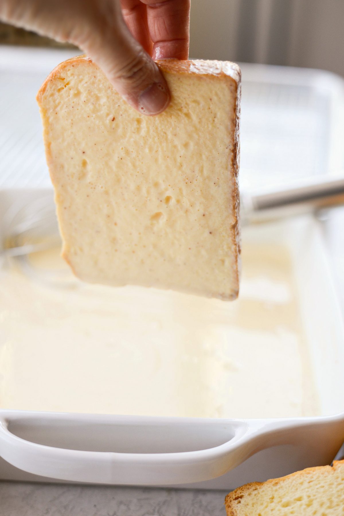 excess custard dripping back into dish