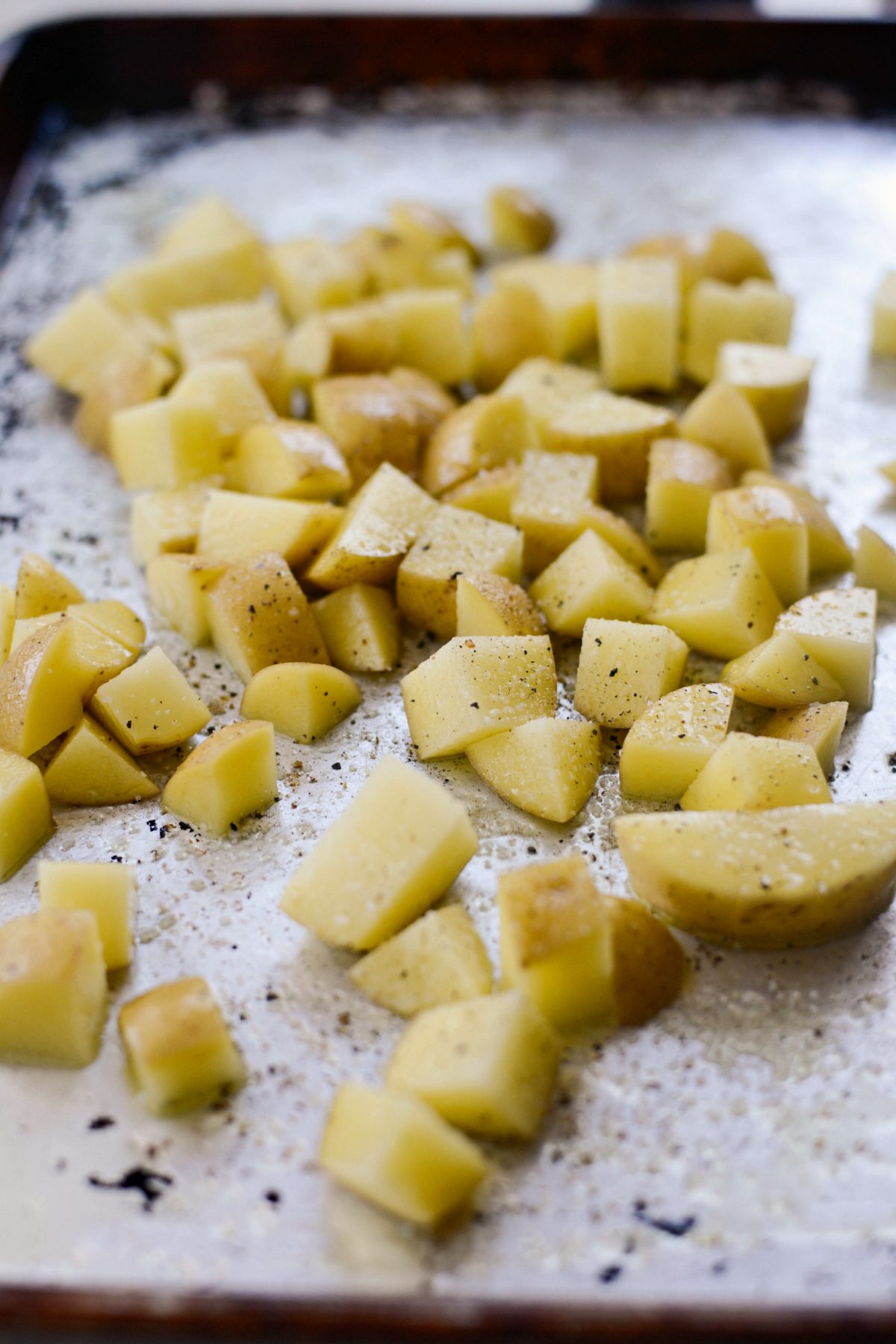 season potatoes and toss in oil.