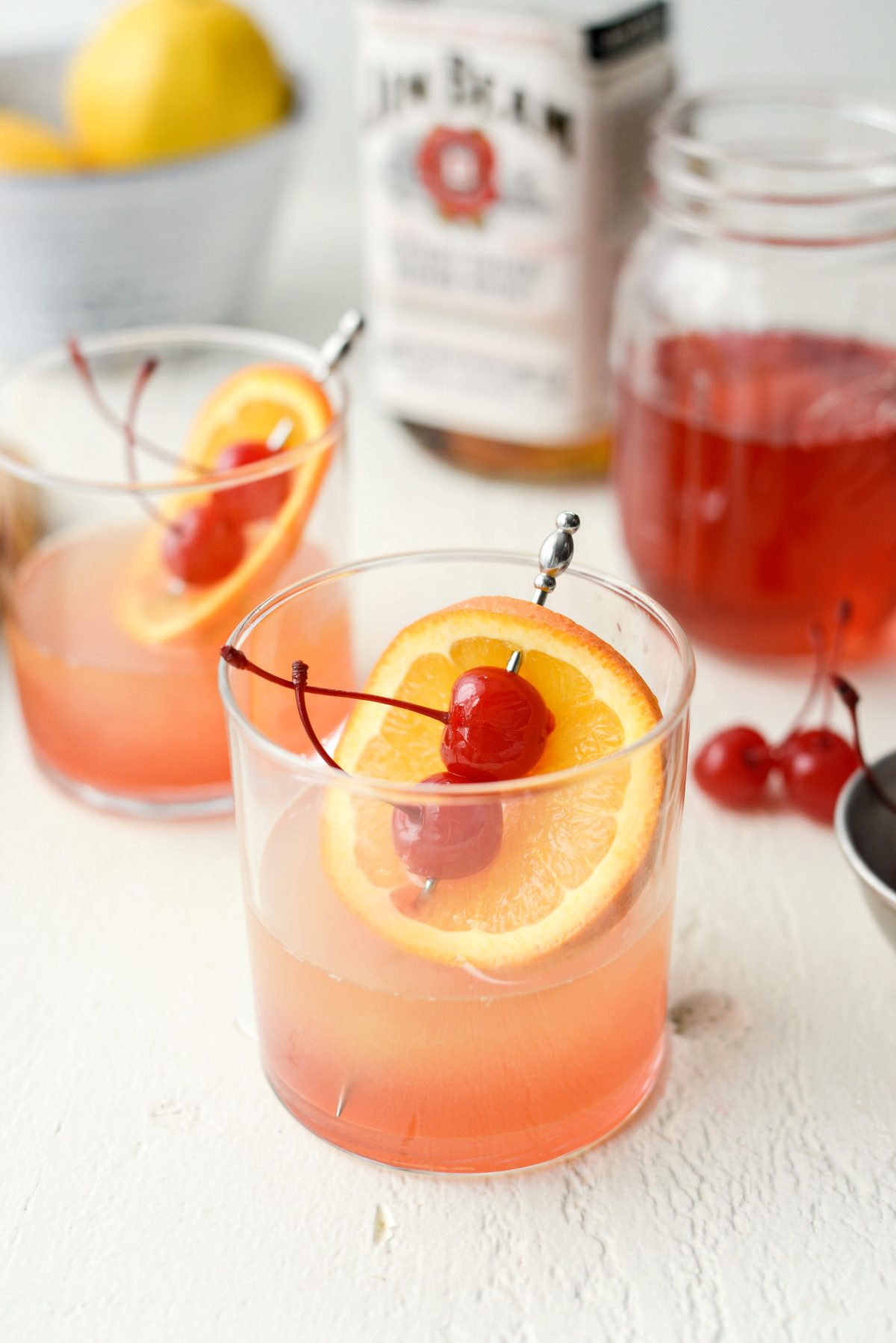 Whiskey Sour Sunrise with two cherries
