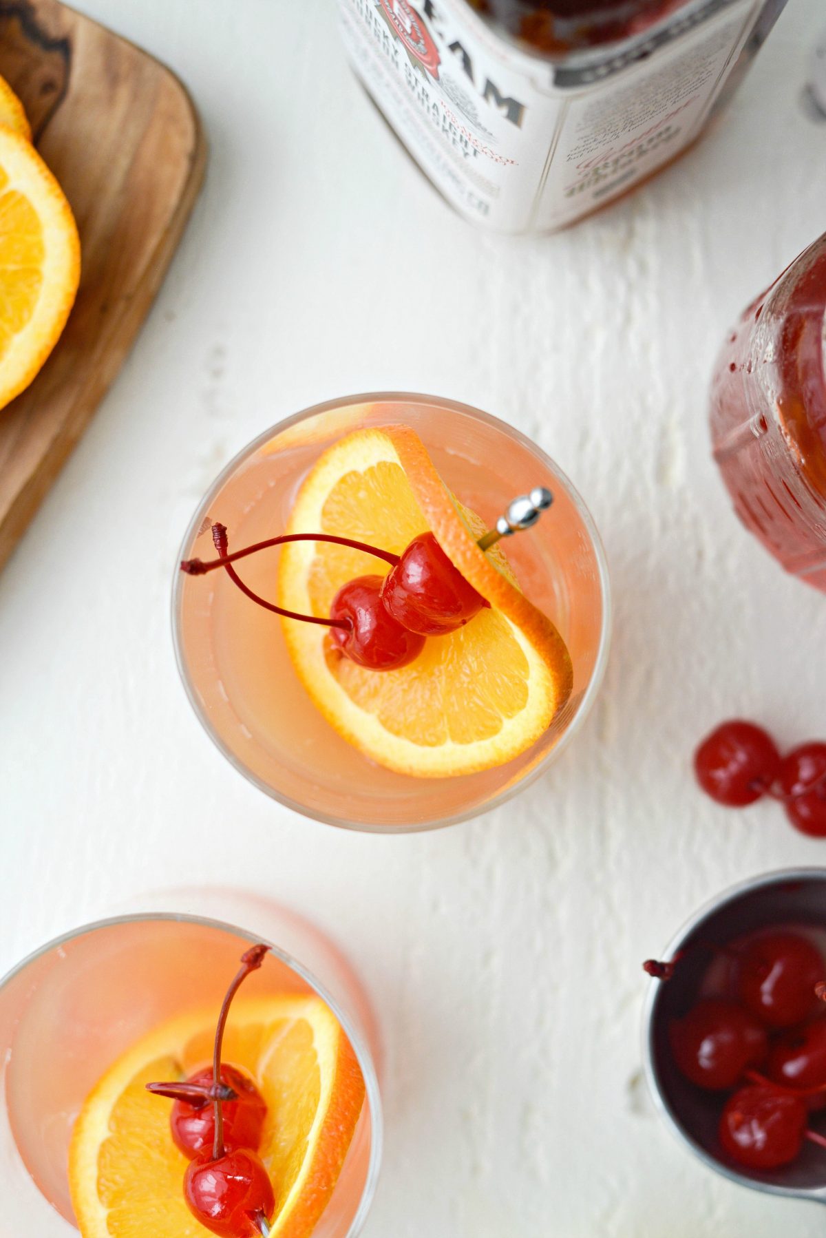 garnish a Whiskey Sour Sunrise with an orange slice and two cherries