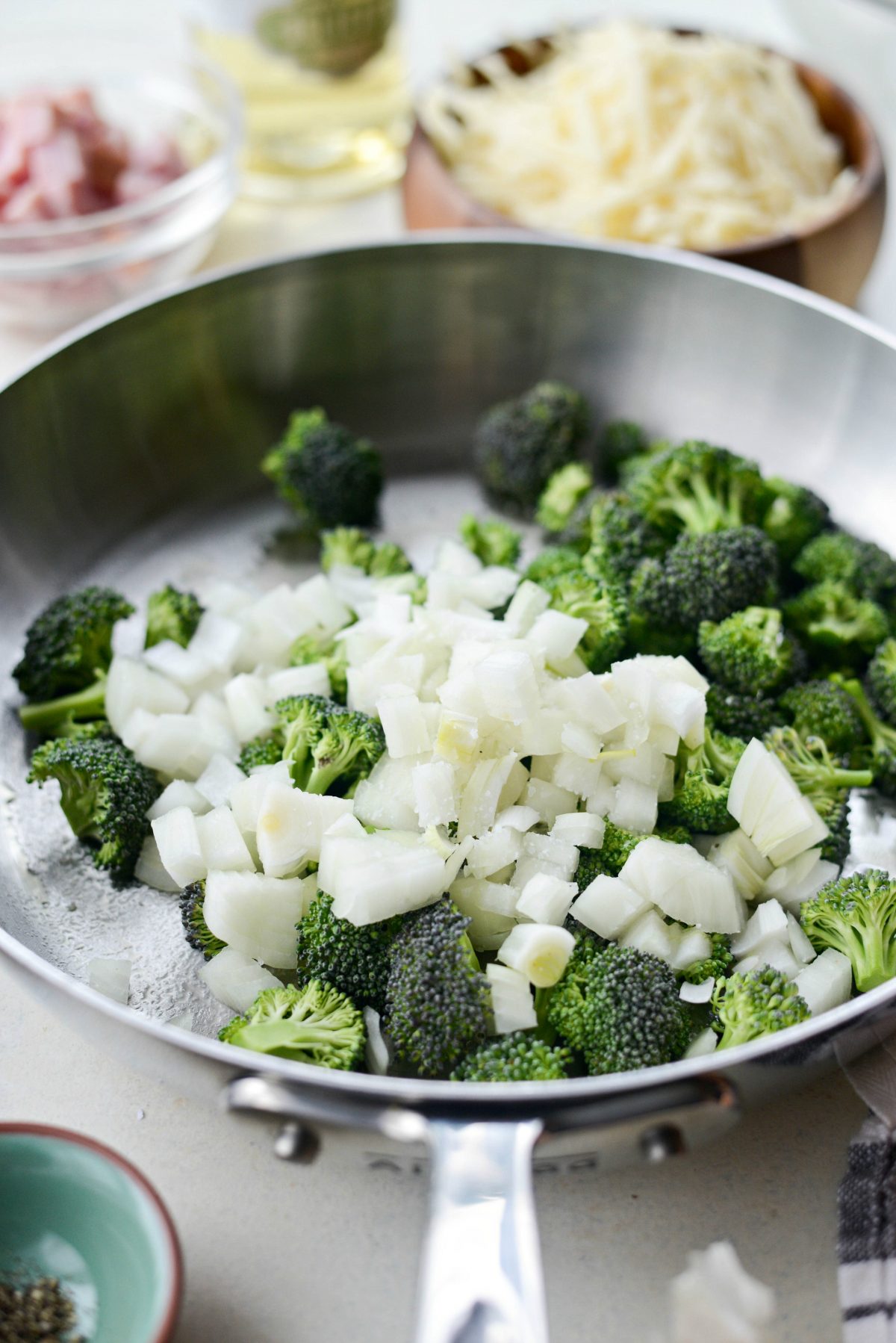 add broccoli and onions to a skillet.