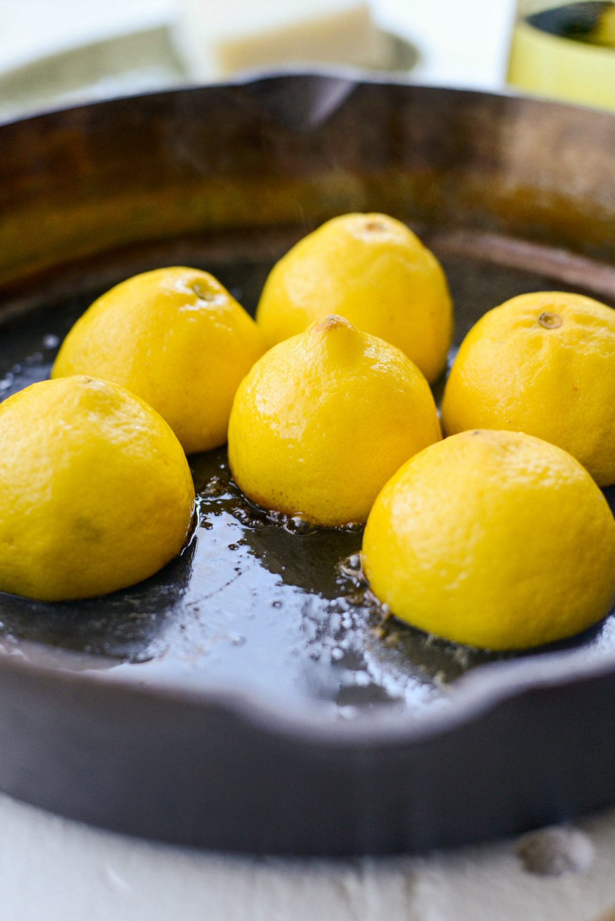 searing lemons in a skillet.