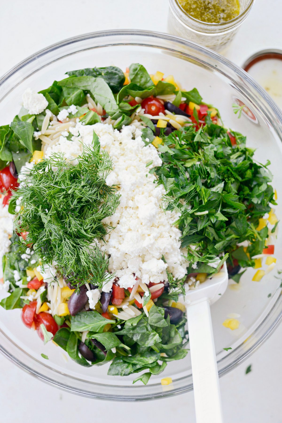 salad ingredients in glass mixing bowl.