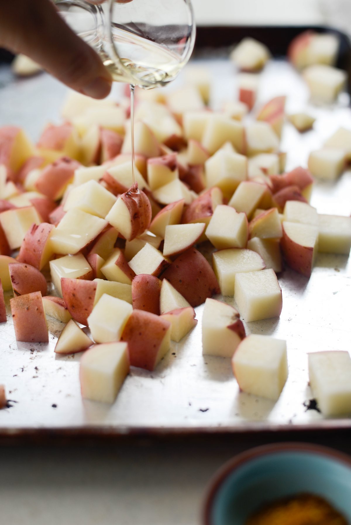 drizzle olive oil over potatoes.