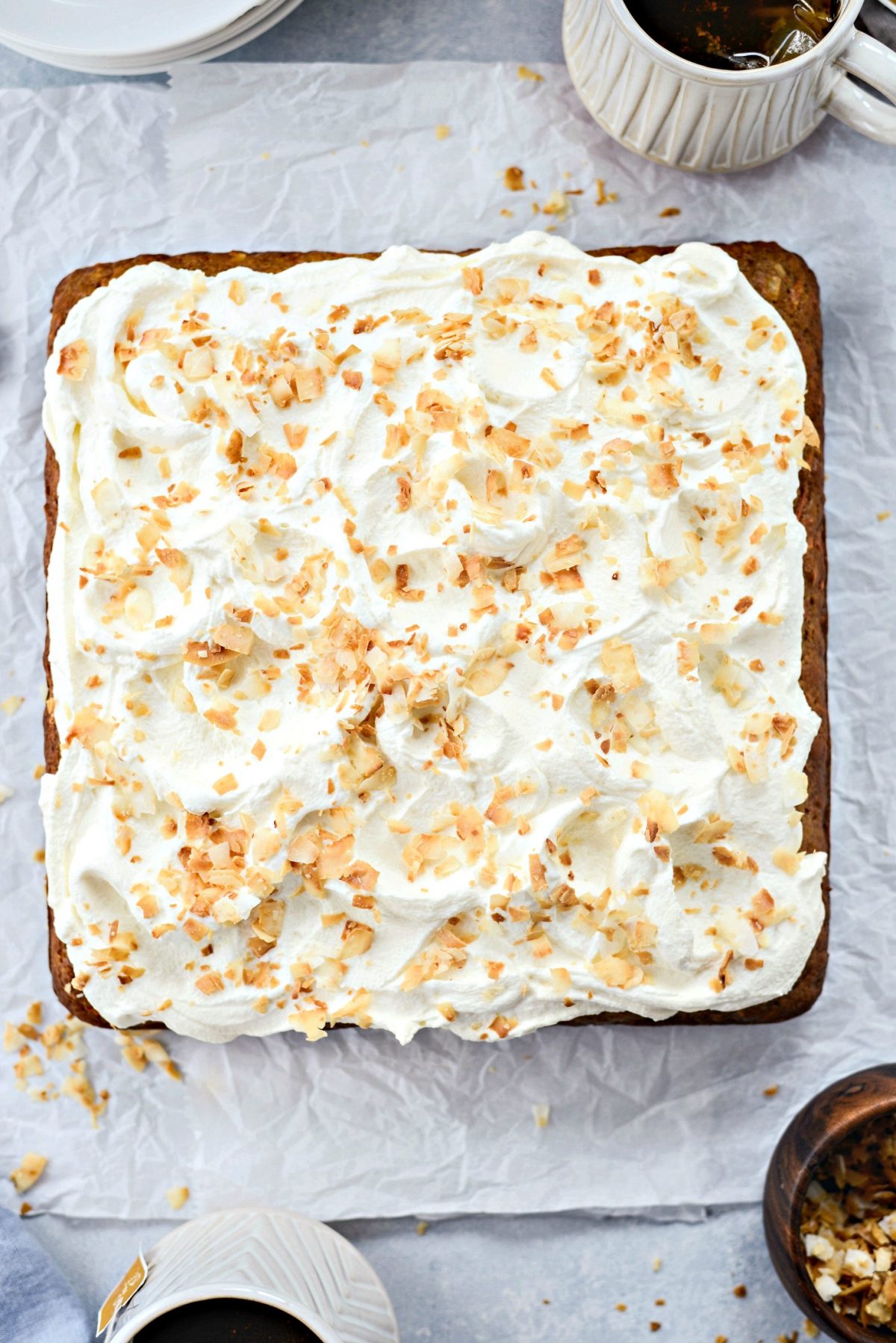 Spread mascarpone frosting and top with more toasted coconut.