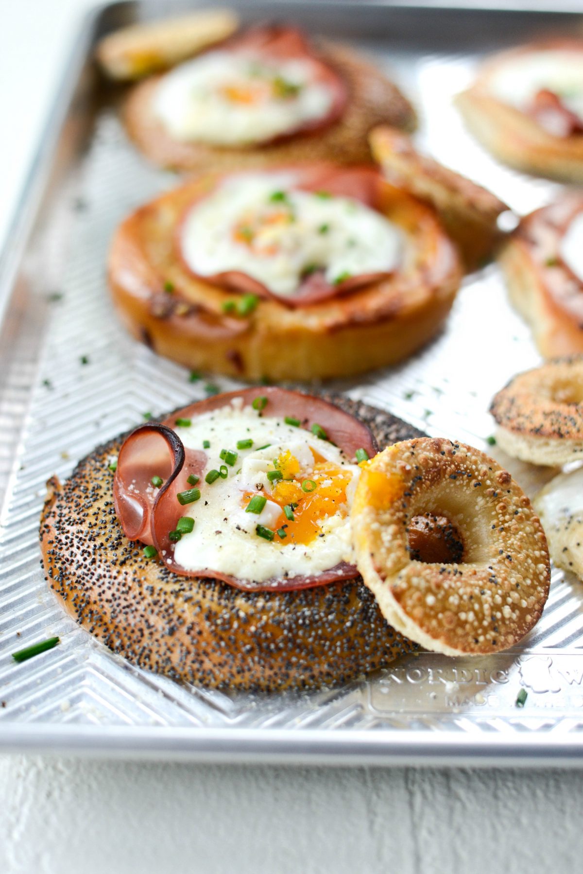 Baked Egg in a Hole Bagels l SimplyScratch.com #bagels #eggs #ham #sheetpan #mothersday #breakfast #easy #recipe