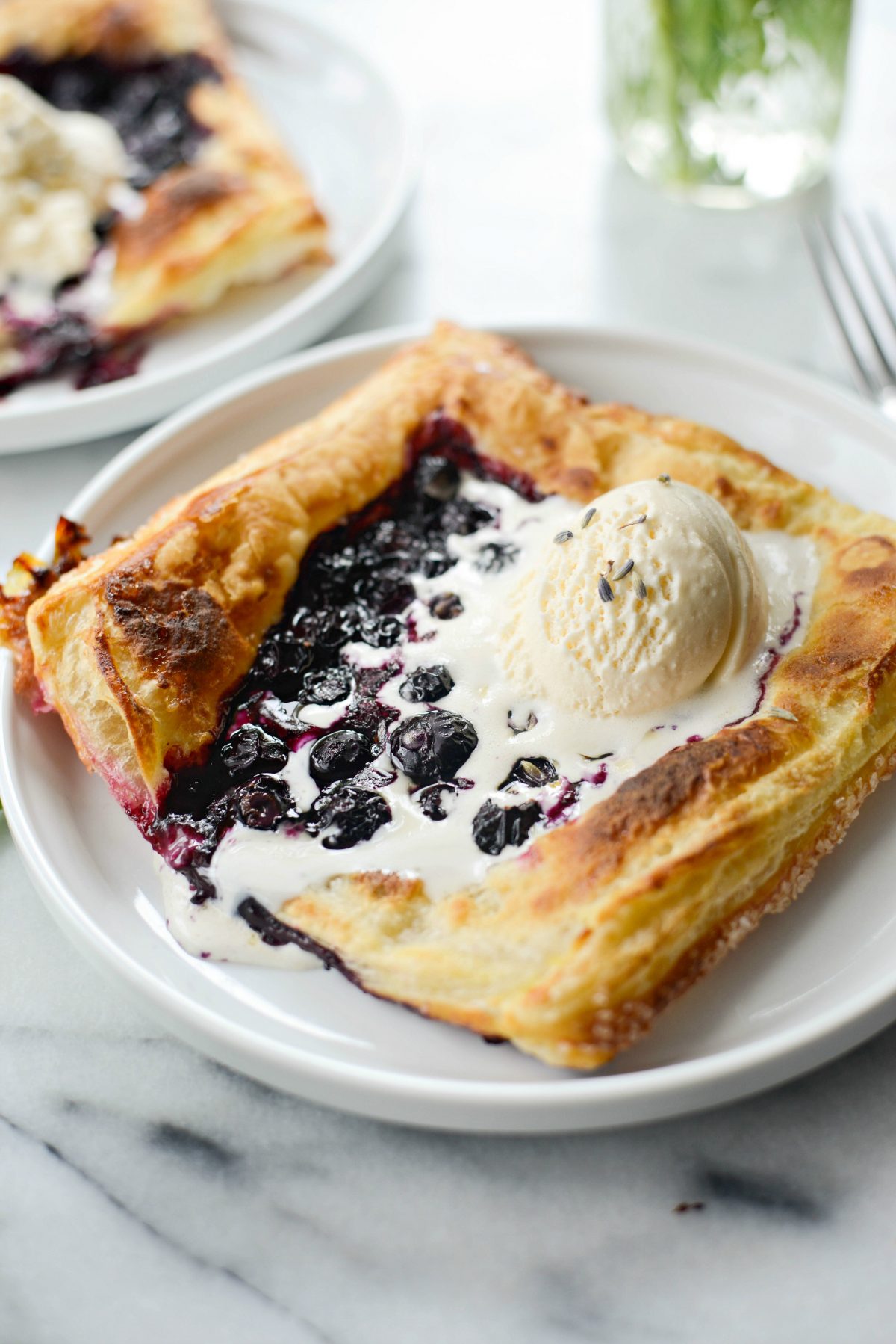 Blueberry Lavender Pastry Pies on white plates