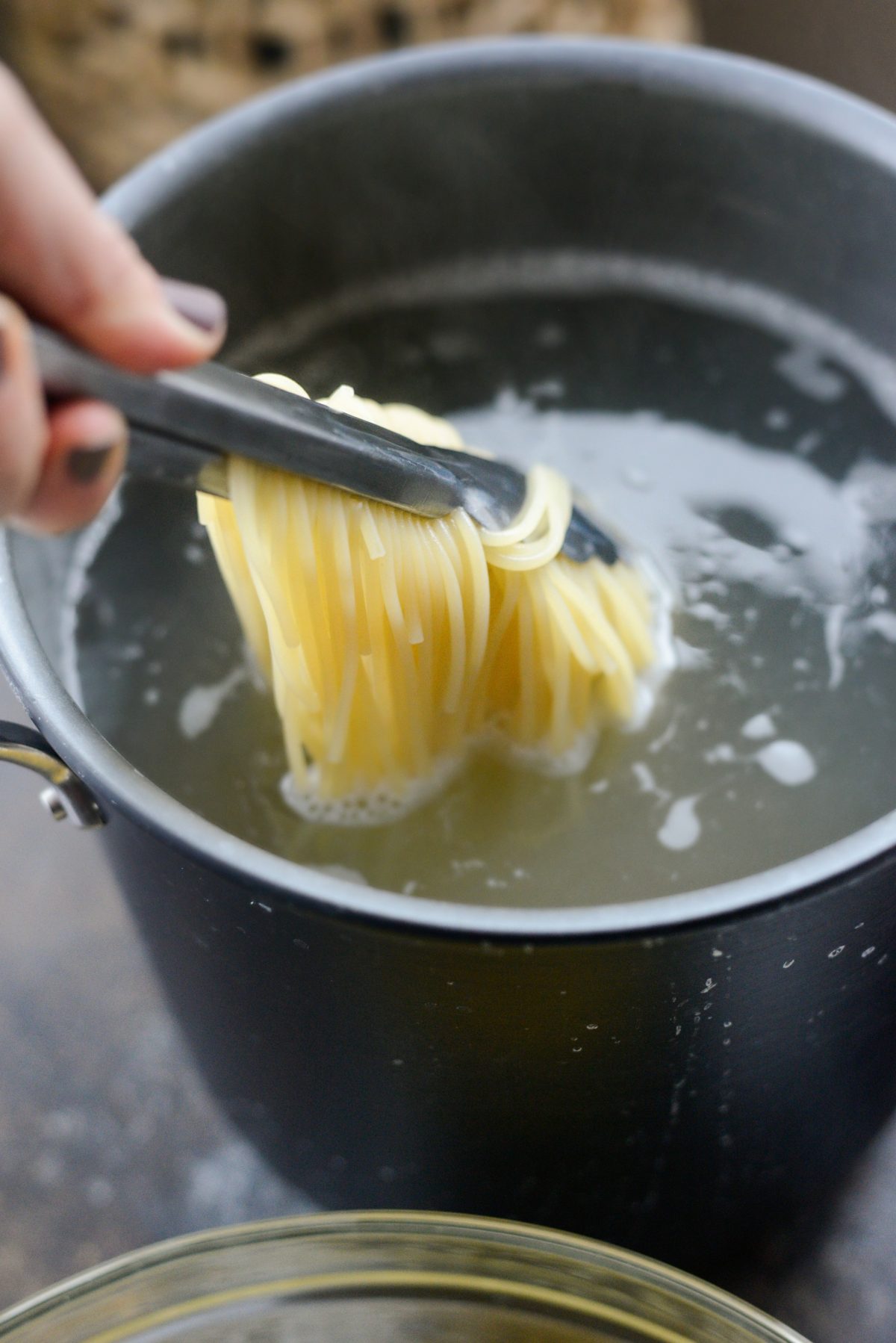 Remove hot cooked pasta from pot
