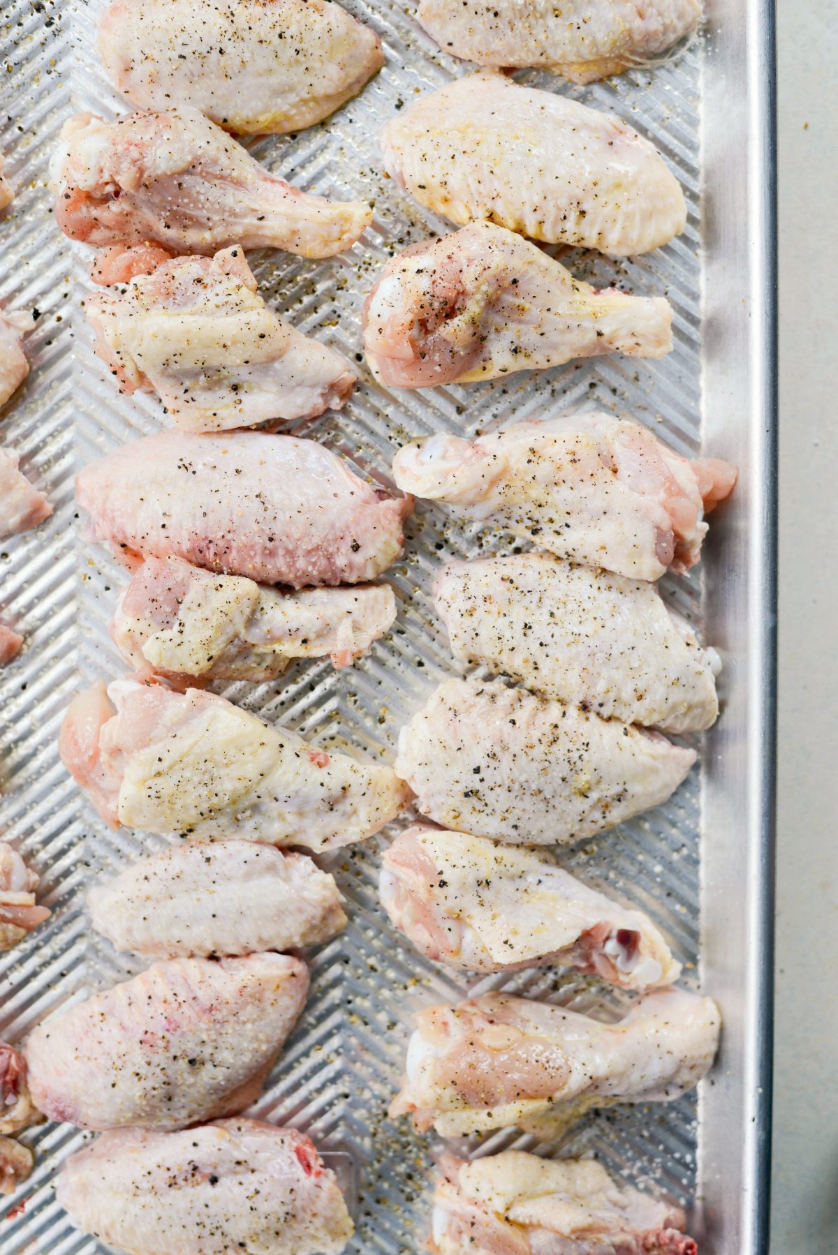 spray with olive oil and season wings with salt and pepper