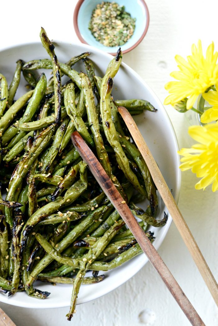 close up of tongs with Grilled Green Beans