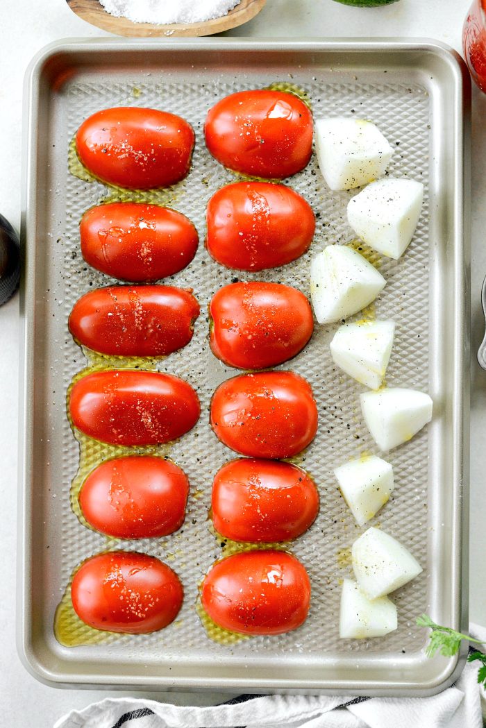 romas and onions on roasting pan