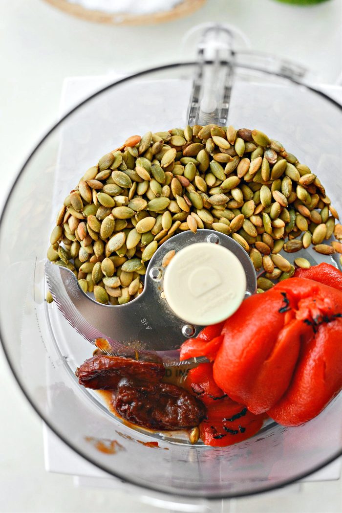 add toasted pepitas, chipotles and roasted red peppers into food processor