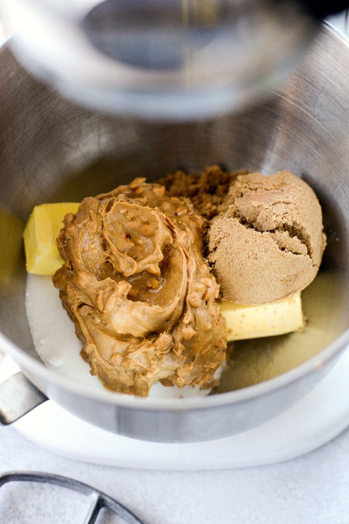 Add butter, peanut butter and both sugars to bowl of stand mixer.