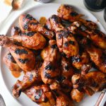 Easy BBQ Chicken Drumsticks on round platter.