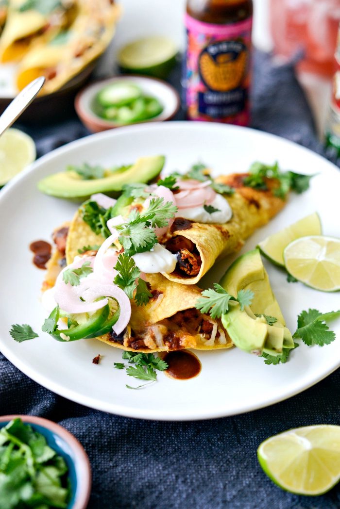 Crisp air fried chipotle chicken black bean tacos with cilantro, jalapeño crema and pickled red onions.