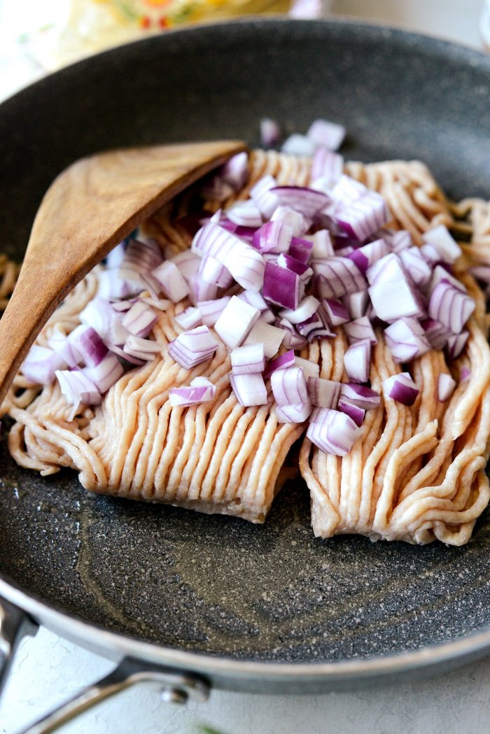 ground chicken and red onion in a skillet