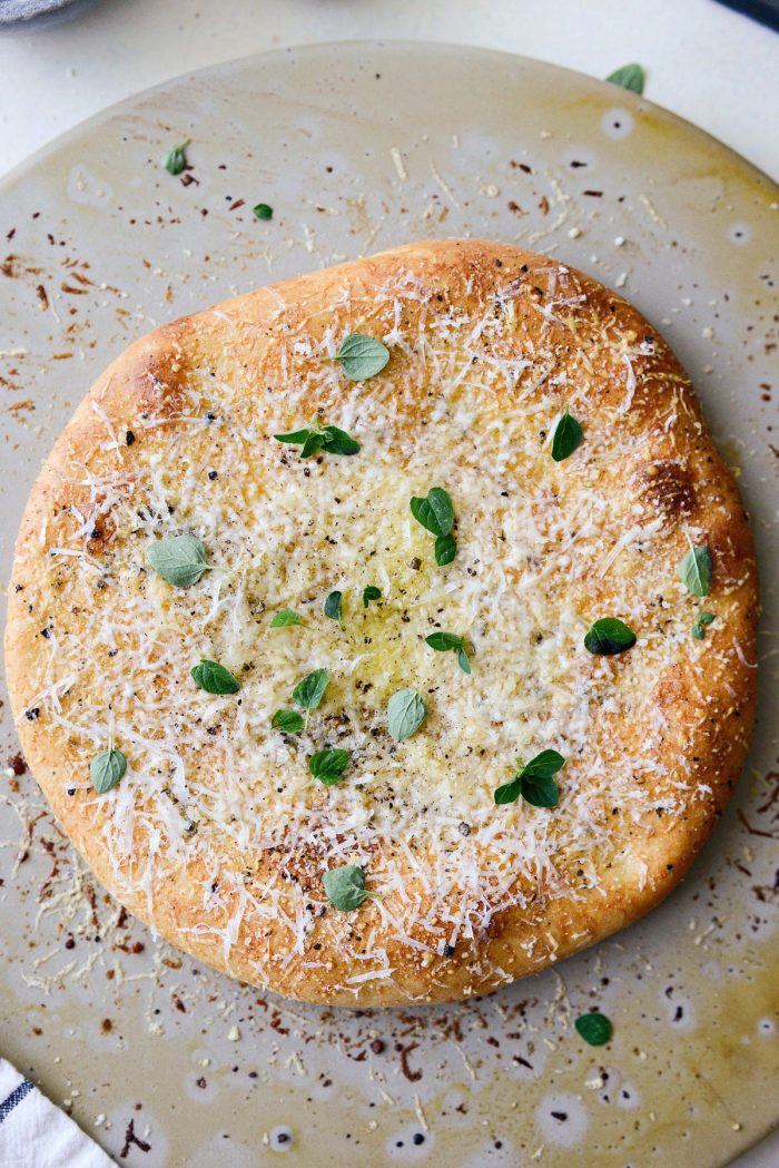 baked pizza with extra cheese, olive oil, black pepper and oregano