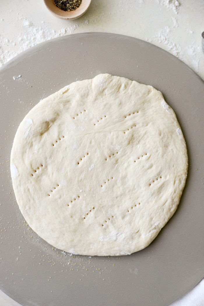 pizza dough pricked with fork