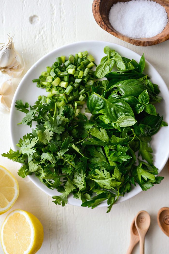 fresh herbs on a white plate