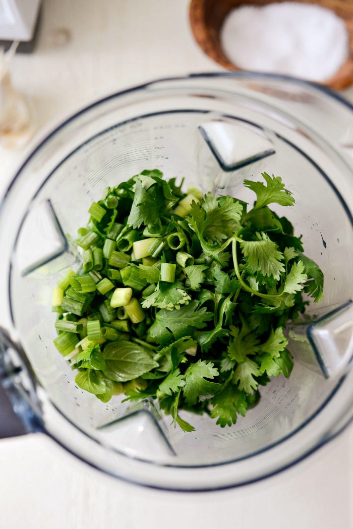 fresh herbs and green onions in blender