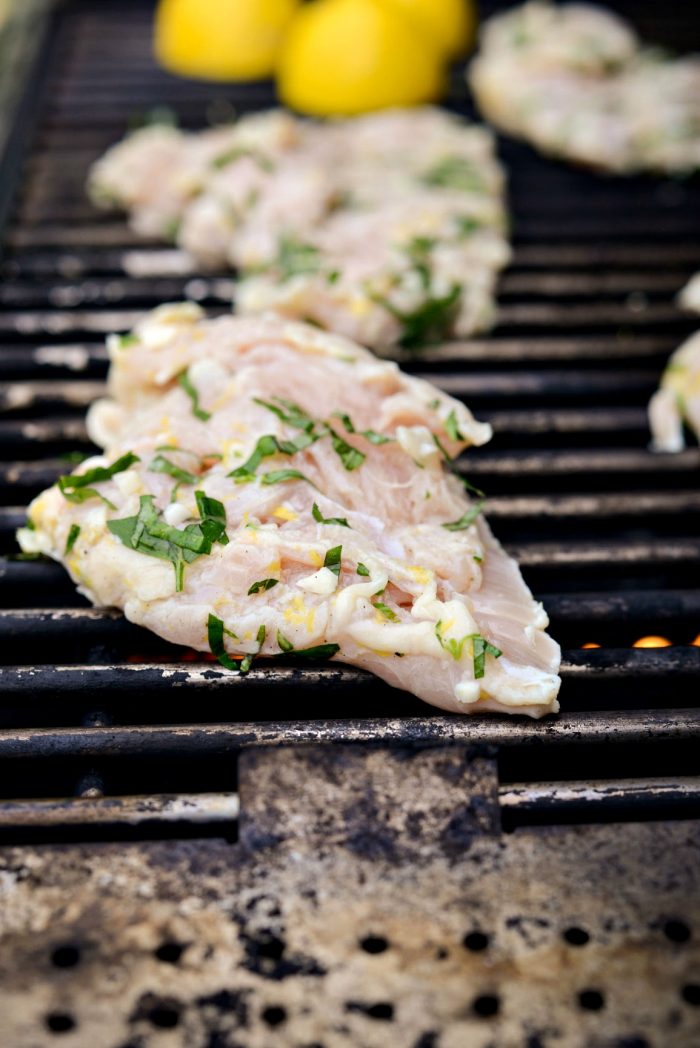 chicken on a grill with lemons