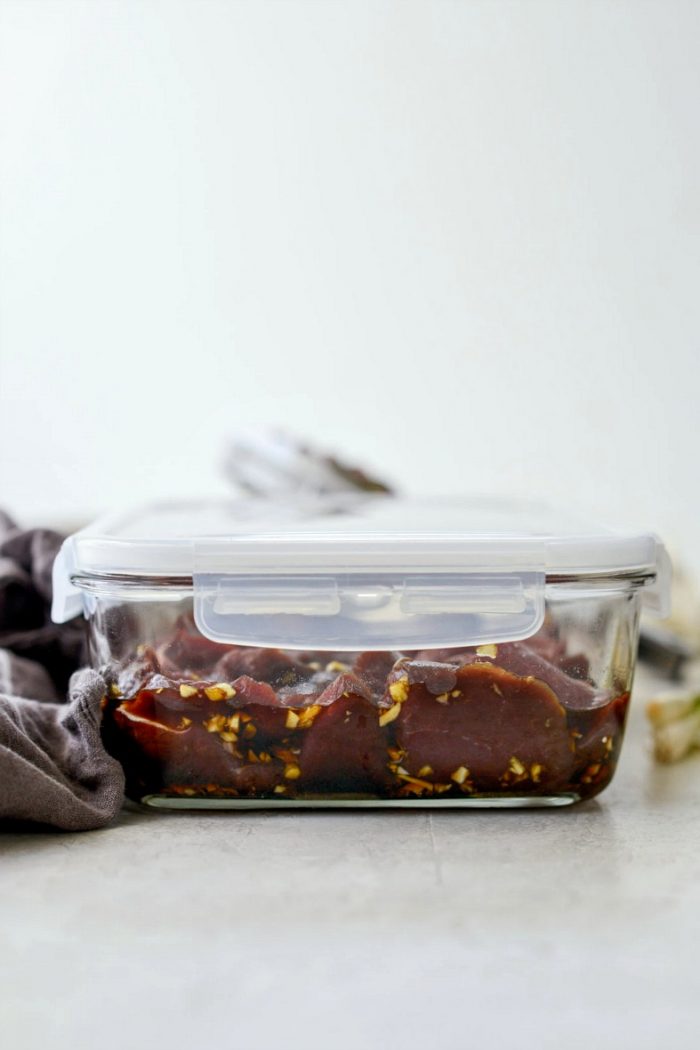 marinade and venison in container with lid