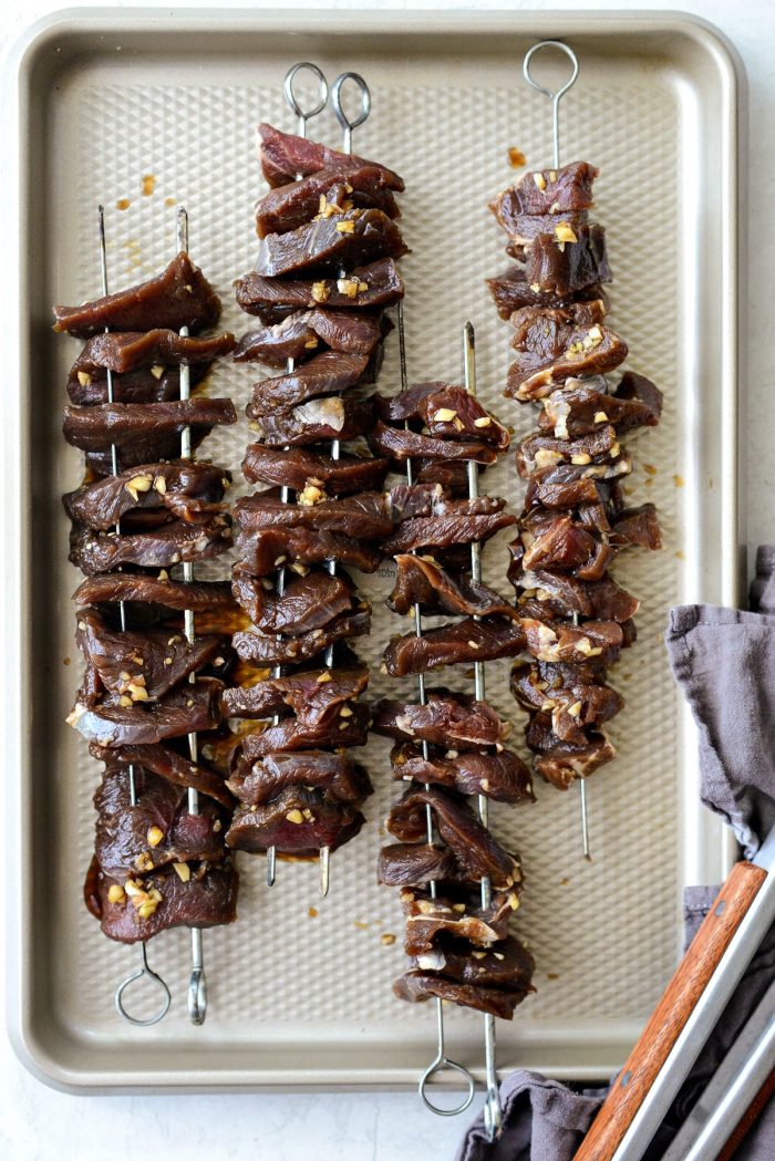 venison backstrap threaded onto skewers