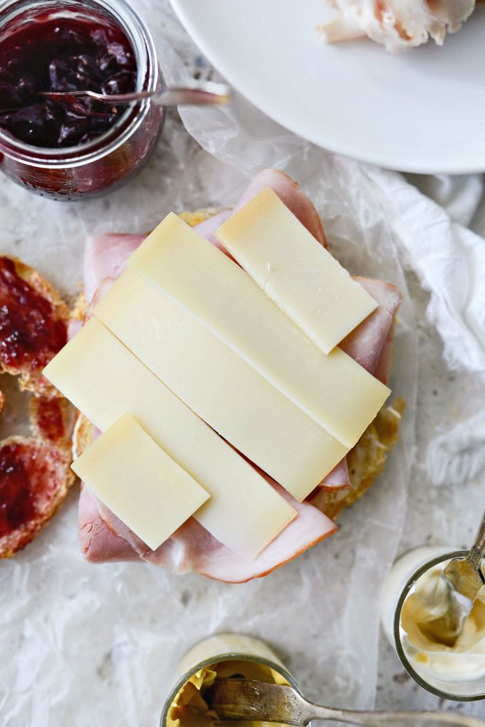 top the ham with slices of gruyere