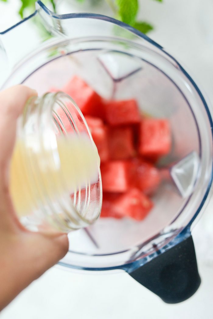 pouring lemon juice into blender