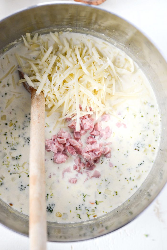 add grated gruyere and diced ham to pot