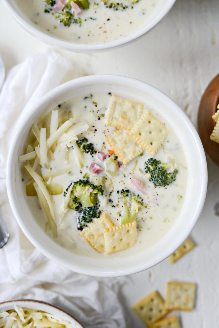 bowl of Broccoli Ham and Swiss Soup with extra cheese and soup crackers.