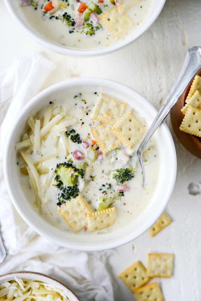 Broccoli Ham and Swiss Soup in bowls with spoon.