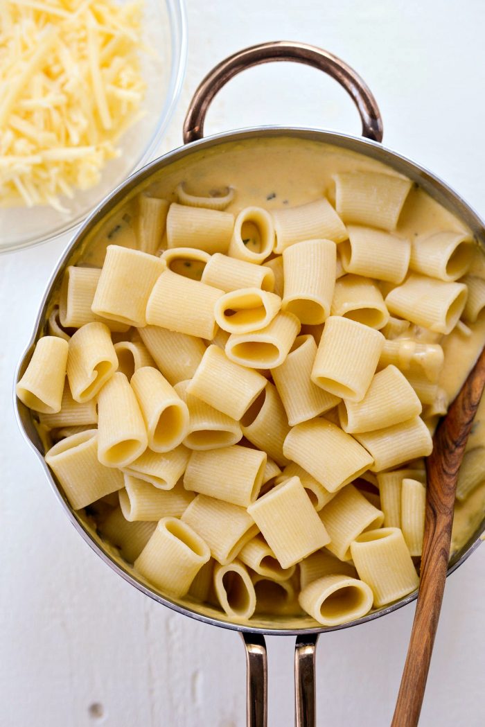 add cooked pasta to cheese sauce