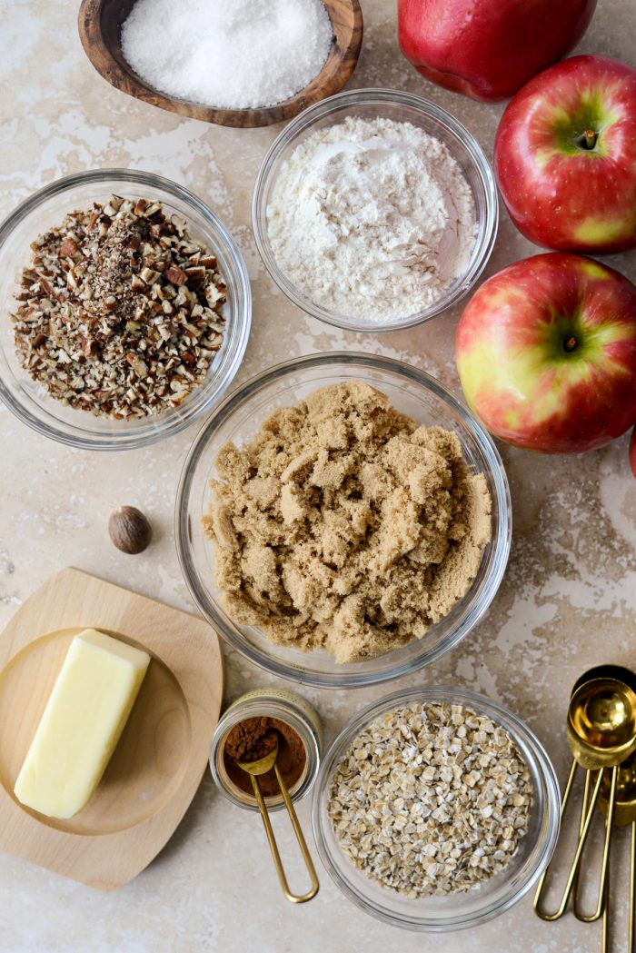 Easy Apple Crisp ingredients; apples, oats, sugar, salt, flour, butter, cinnamon, nutmeg and pecans.