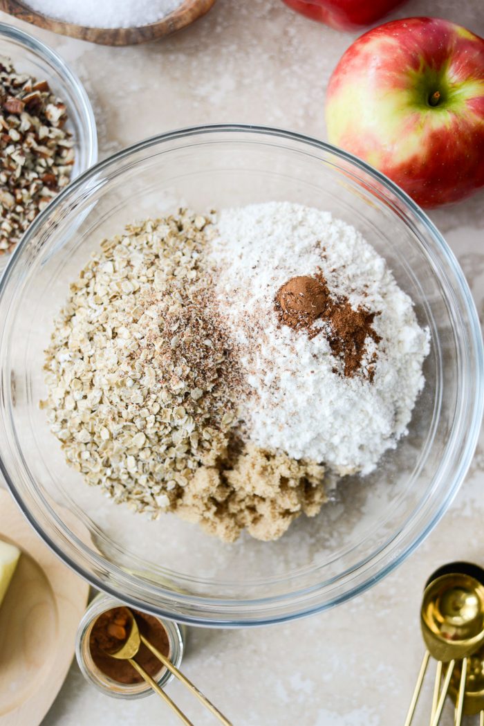 sugar, oats, flour, cinnamon, nutmeg and salt in a glass mixing bowl