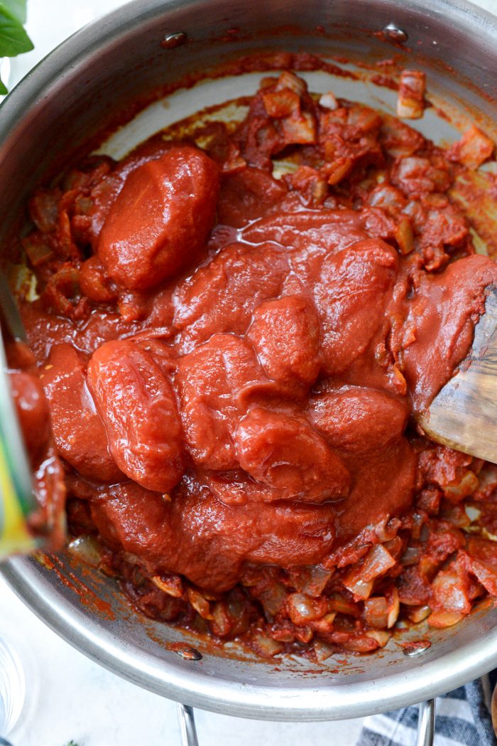 3 cans whole san marzano tomatoes to the pan.