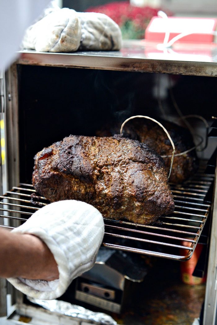 pulling out the rack with the smoked pork shoulder (butt).