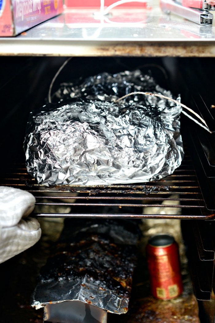 slide wrapped pork shoulder back into smoker.