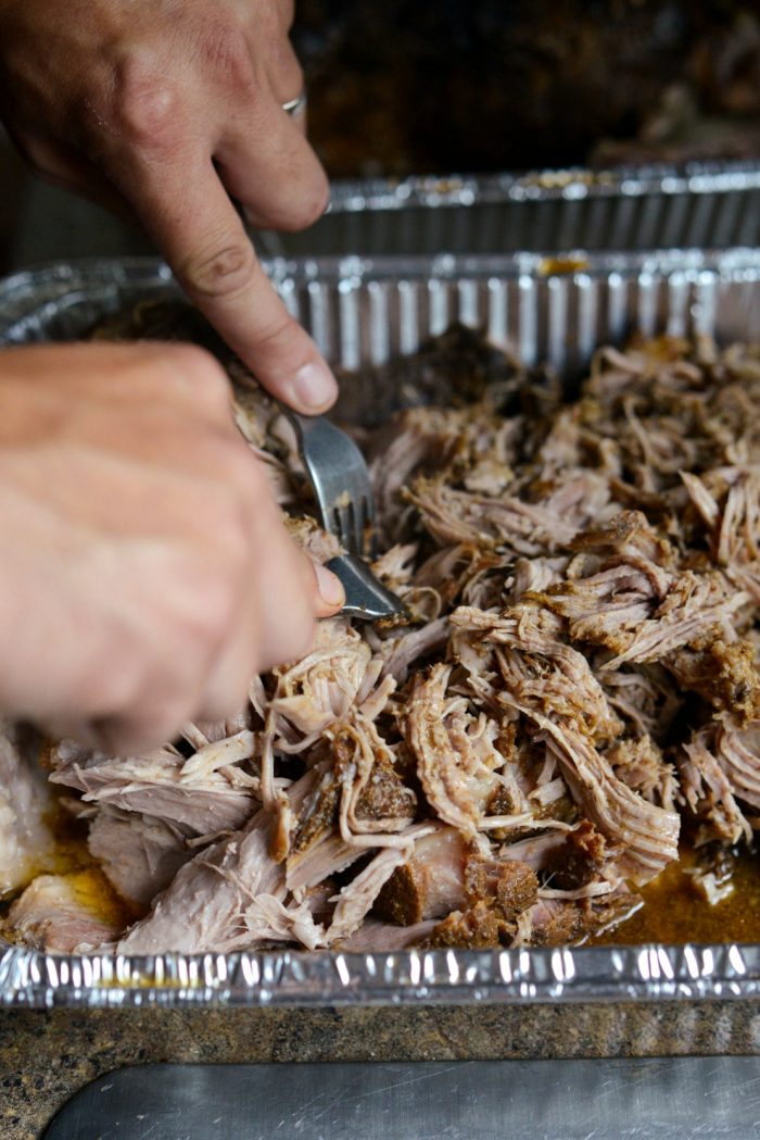 transfer smoked pork shoulderto tray and shred with forks.