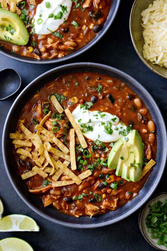 Southwest Chicken Chili with toppings in a black bowl.