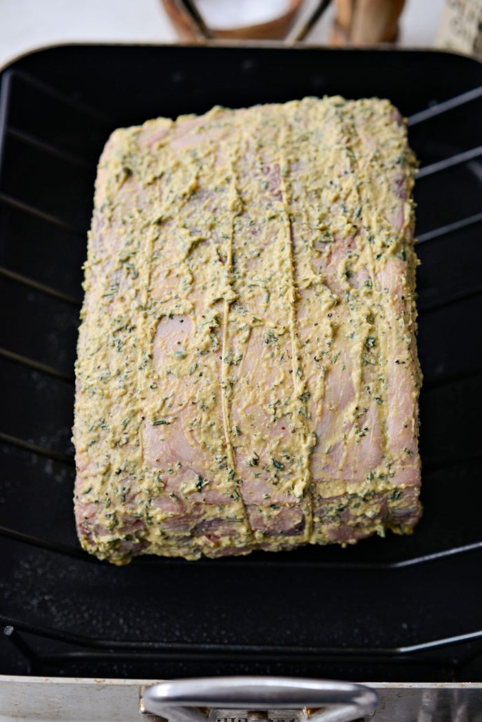 dijon rosemary rib roast on rack in roasting pan.