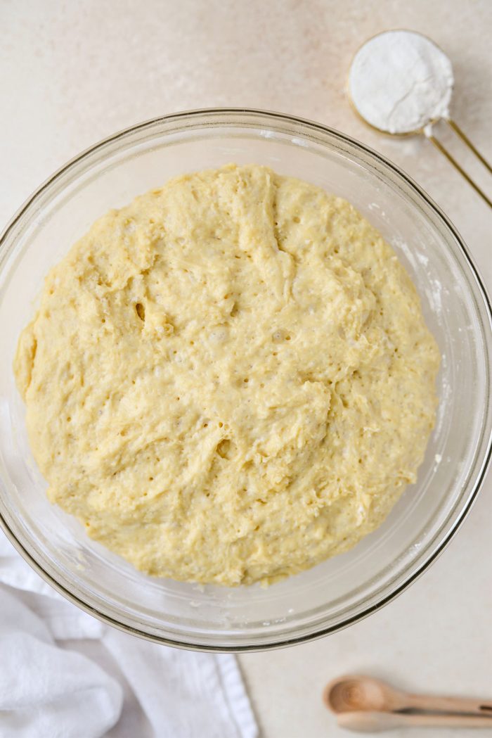 risen dough in glass bowl.