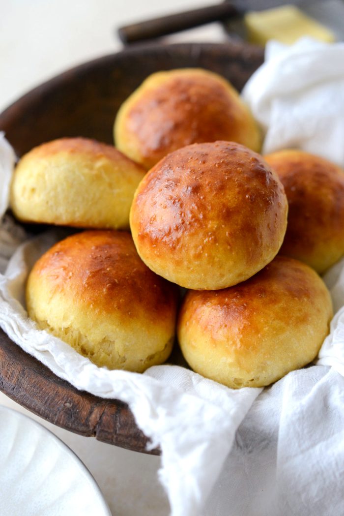 wooden bowl of Brioche Dinner Rolls.