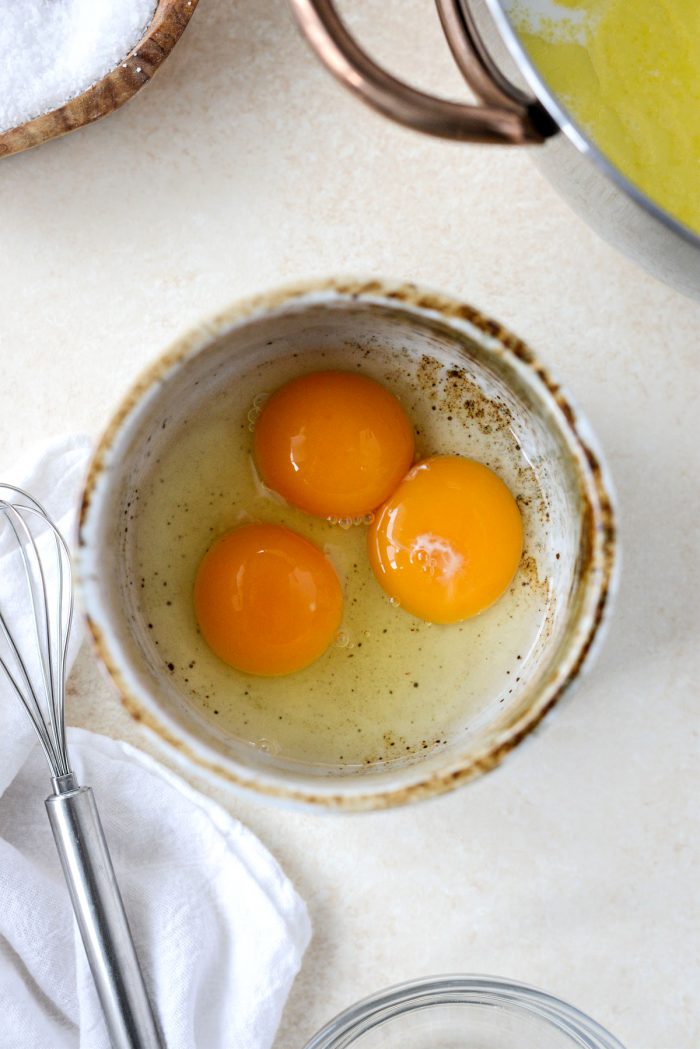 1 egg plus 2 egg yolks in a bowl.