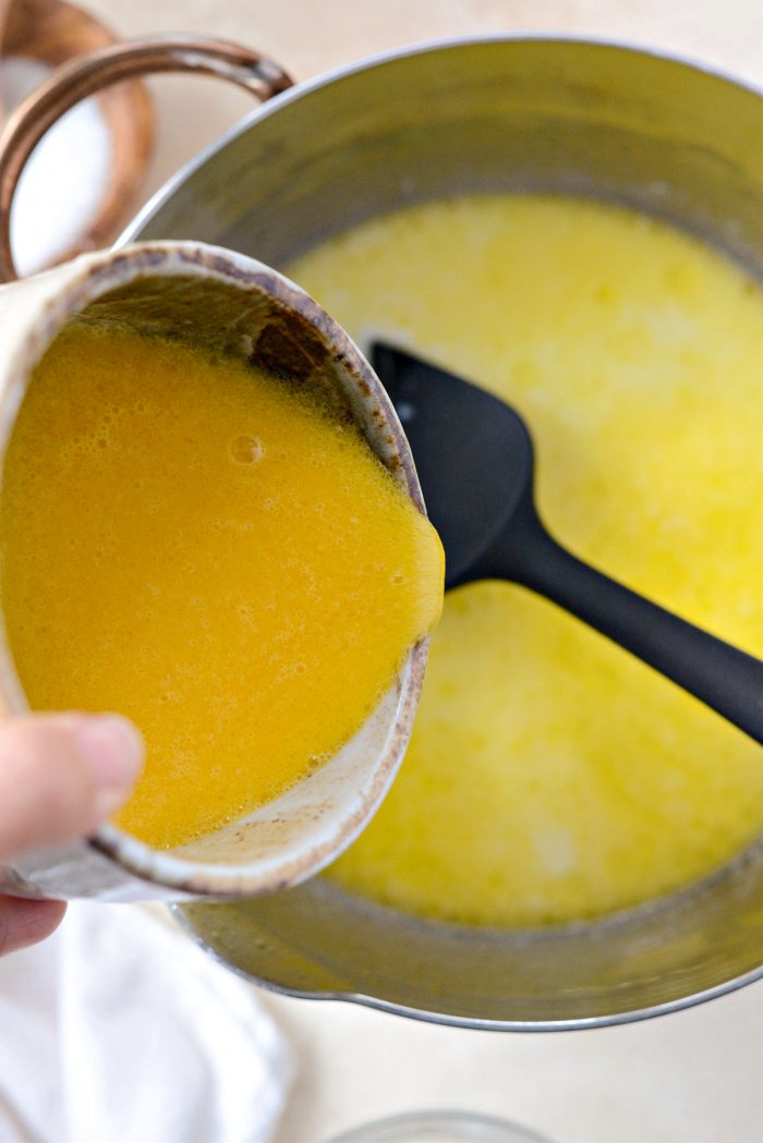 pouring tempered eggs back into saucepan.