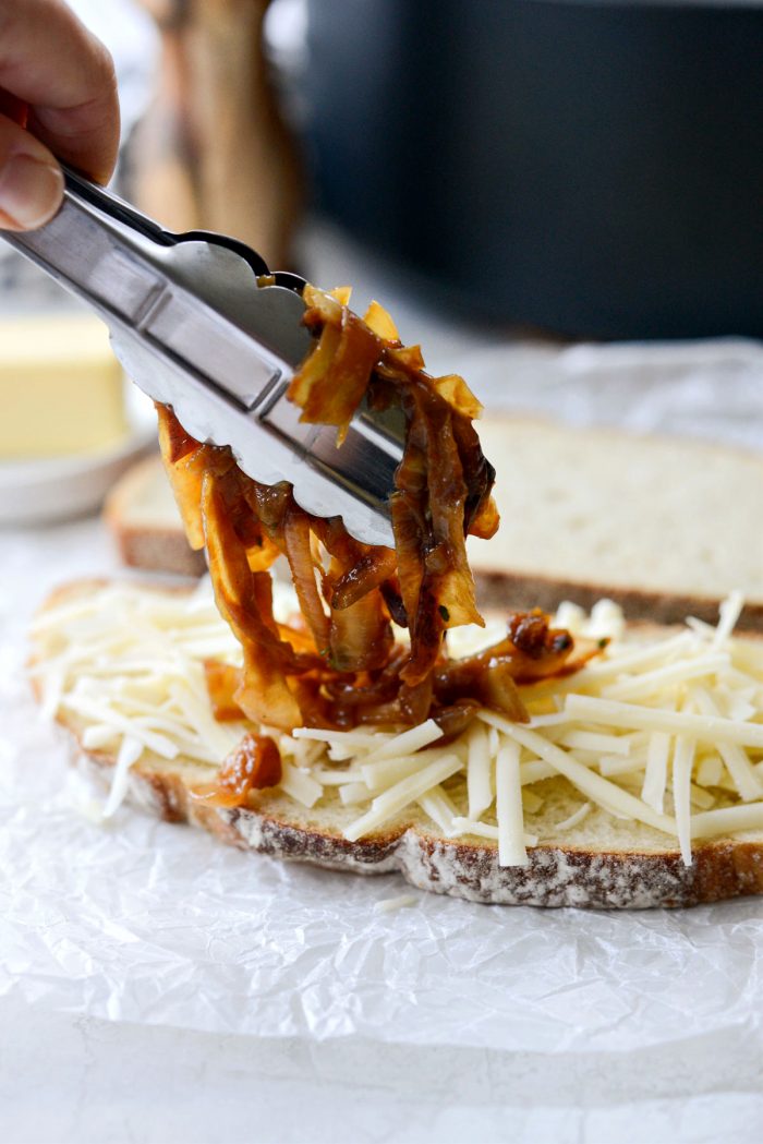 Topping gruyere with caramelized onions.