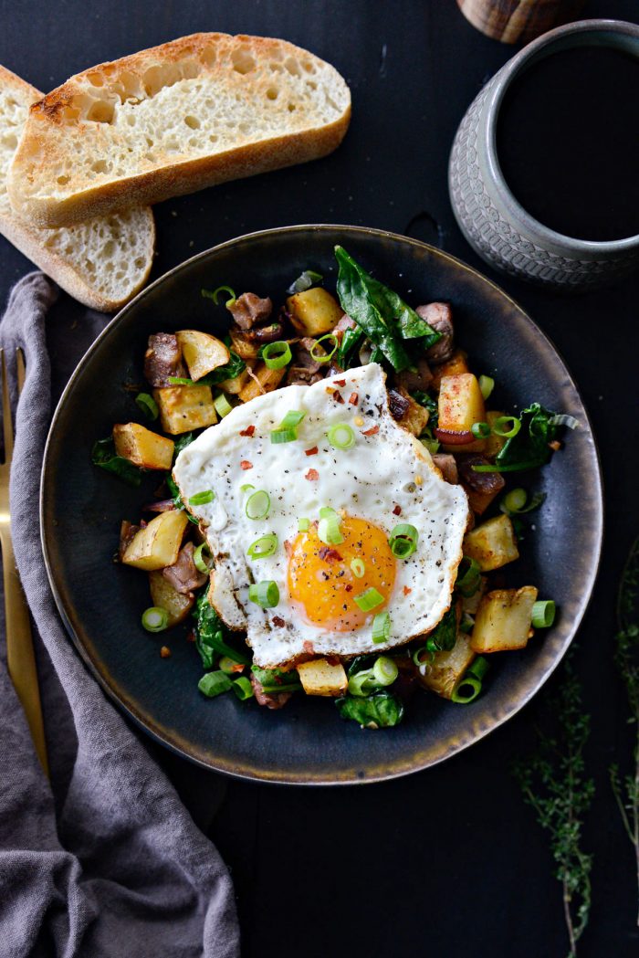 Leftover Prime Rib Breakfast Hash topped with fried egg and green onion.