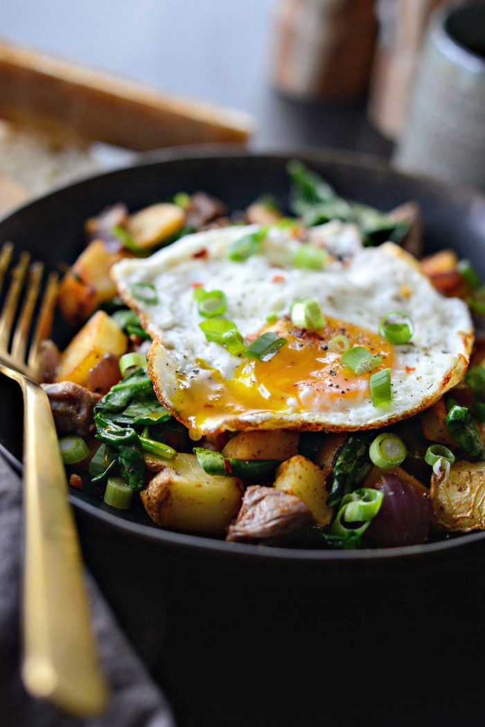 Leftover Prime Rib Breakfast Hash in black dish with gold fork.