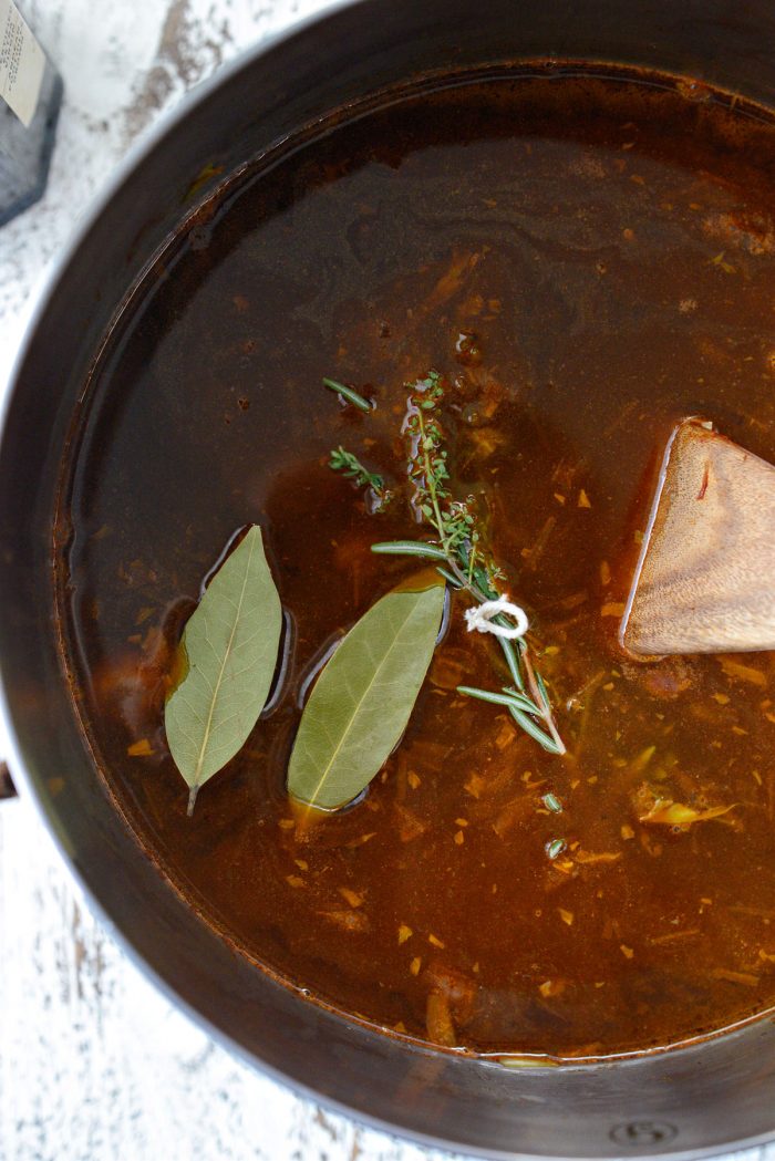 bay leaf and herb bundle added to the soup.