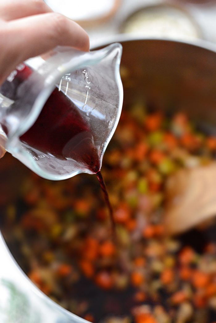 pouring cabernet sauvignon into the pot.